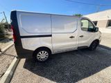 a white van parked in a parking lot with a blue sky in the background