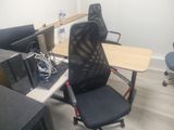 a desk with a chair and a computer on it