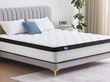 a close up of a mattress on a bed frame in a bedroom