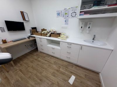 a desk with a computer and a chair in a room