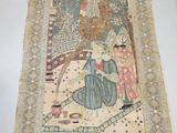 an image of a rug hanging on a wall with a person standing next to it