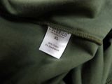 a close up of a green jacket with a tag on it
