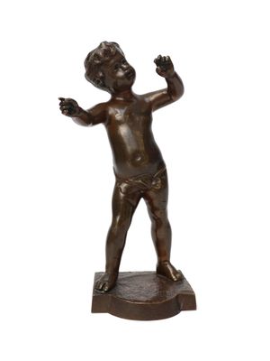 bronze statue of a boy holding a tennis racquet on a white background