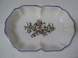 a white plate with a blue border and a flower design on it
