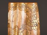 a close up of a vase with gold decorations on it