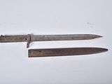 two old knives sitting on top of a table next to each other