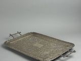 an antique silver tray with handles and handles on a white surface