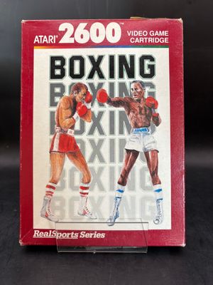 une image représentant une boîte sur laquelle figure une illustration d'un combat de boxe
