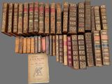 several old books stacked on top of each other on a table