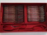 many spoons and forks in a red box