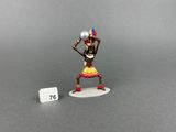 a small figurine of a woman with a ball in her hand