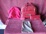 a pink bag and a pink purse sitting on a pink chair