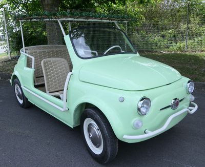 a small green car that is parked in the parking lot