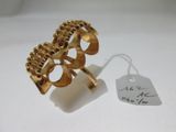 an image of a gold ring on a white surface with a price tag