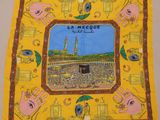 a yellow scarf with a picture of the kaabah mosque