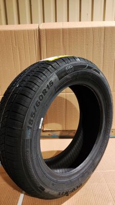 a close up of a tire on a cardboard box on a floor