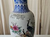 a blue and white vase sitting on a white table