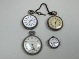 several different types of pocket watches are displayed on a white surface