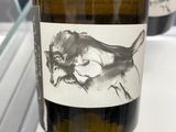 a bottle of wine with a drawing of a cat on it