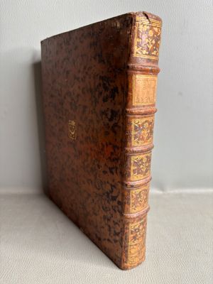 an old book sitting on top of a table next to a wall