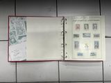 a binder with stamps on it sitting on a tile floor