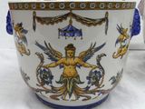 a white vase with a blue and gold decoration on it
