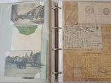 a binder with a lot of old postcards on it