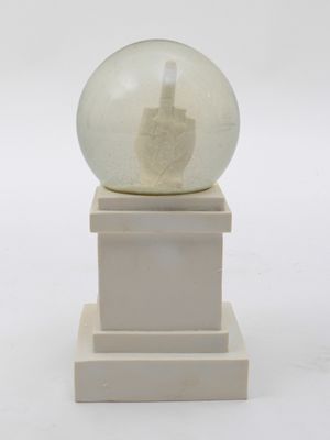 a snow globe sitting on top of a white pedestal