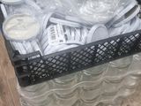 a cart full of plastic cups and spoons on the floor