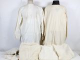 two mannequins are sitting on top of a white table