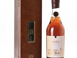 a bottle of liquor sitting in front of a wooden box