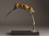 bronze sculpture of birds perched on a branch on a gray background