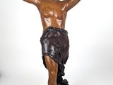 statue en bronze représentant un homme tenant une croix, posée sur un socle en marbre