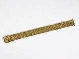 a close up of a metal ruler on a white surface