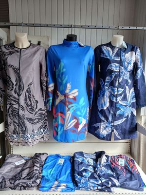 three dresses on display on a shelf in a room