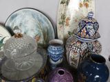 many different vases and plates on the table