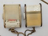 two old radio ' s sitting on a table next to each other