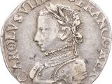 a close up of a silver coin with a woman ' s head on it