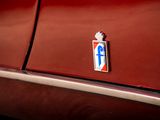 a red car with a blue cross on the side of it