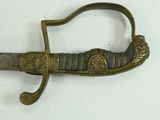 a very old looking dagger with a handle on a white surface