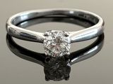 an image of a diamond ring on a reflective surface