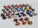 a lot of toy cars that are on a white surface