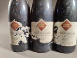 three bottles of wine sitting next to each other on a table