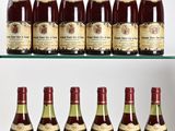 several bottles of wine are lined up on a glass shelf