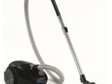 a black and silver vacuum cleaner with a hose on top of it