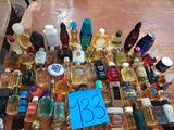 a lot of perfume bottles on a table with a price tag