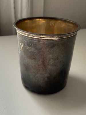 a silver cup that is sitting on a table