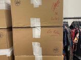 many boxes of clothes on a rack in a room