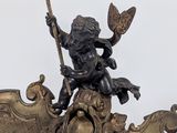 a statue of a little boy on top of a boat
