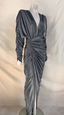 a mannequin dress on a mannequin stand against a white backdrop